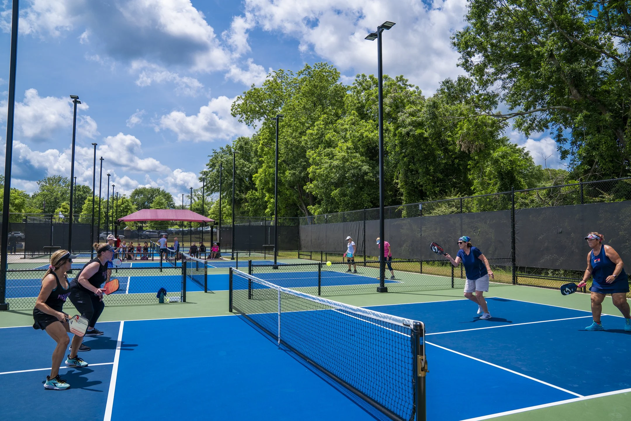 House of Pickleball, Newnan, GA – Pickleball courts surrounded by lush trees and lined with carefully planned walkways enabling proper pedestrian flow throughout the facility.