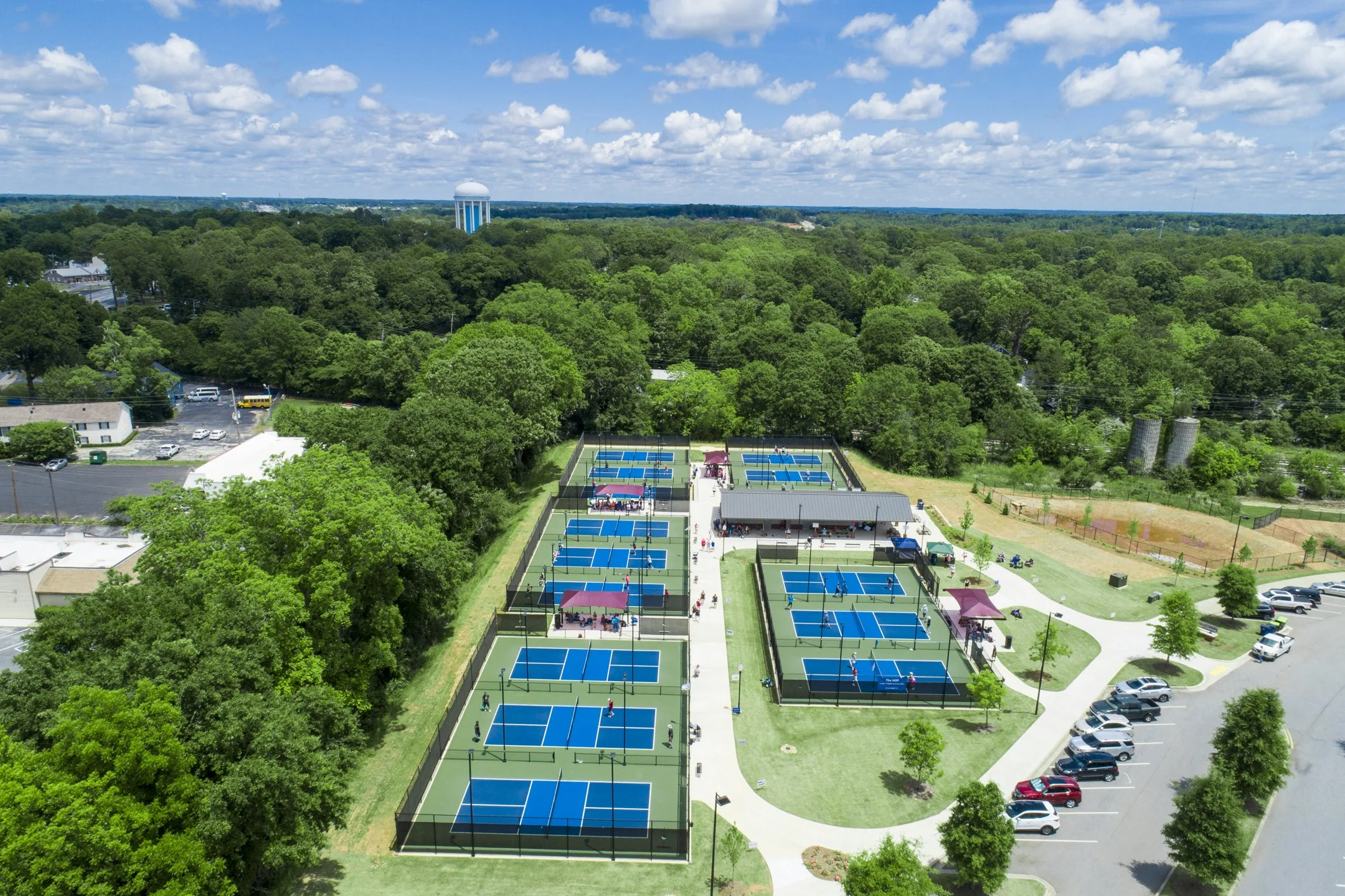The House of Pickleball, Newnan, GA - Aerial view showing 15-court facility and shade structure for players and visitors.