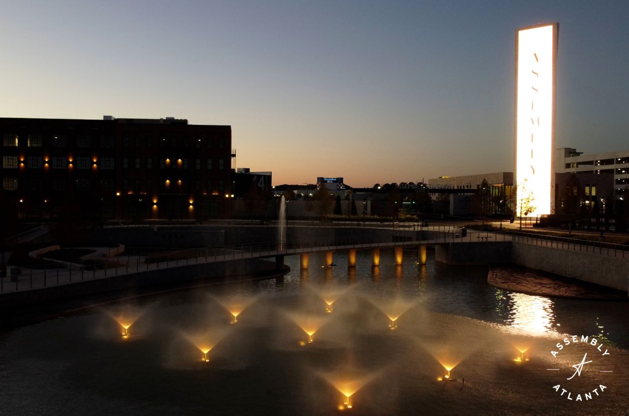 Fountains in a pond at dusk outside Assembly Atlanta