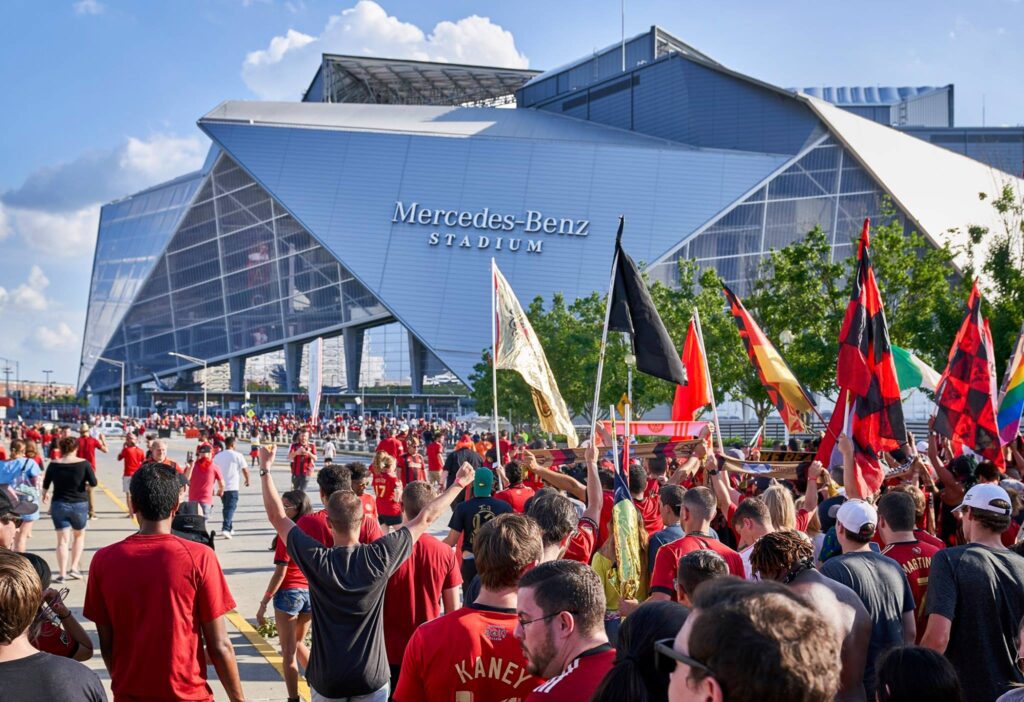 People walking into Mercedes Benz Stadium
