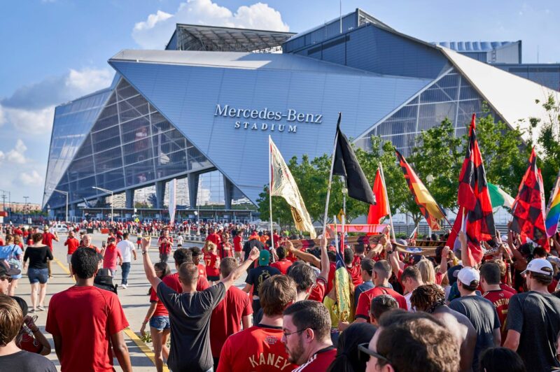 People walking into Mercedes Benz Stadium