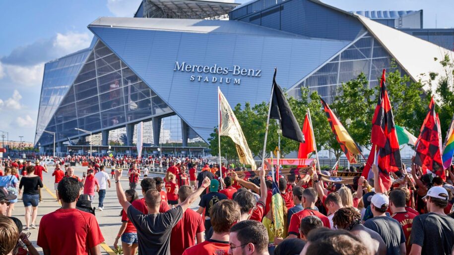 People walking into Mercedes Benz Stadium