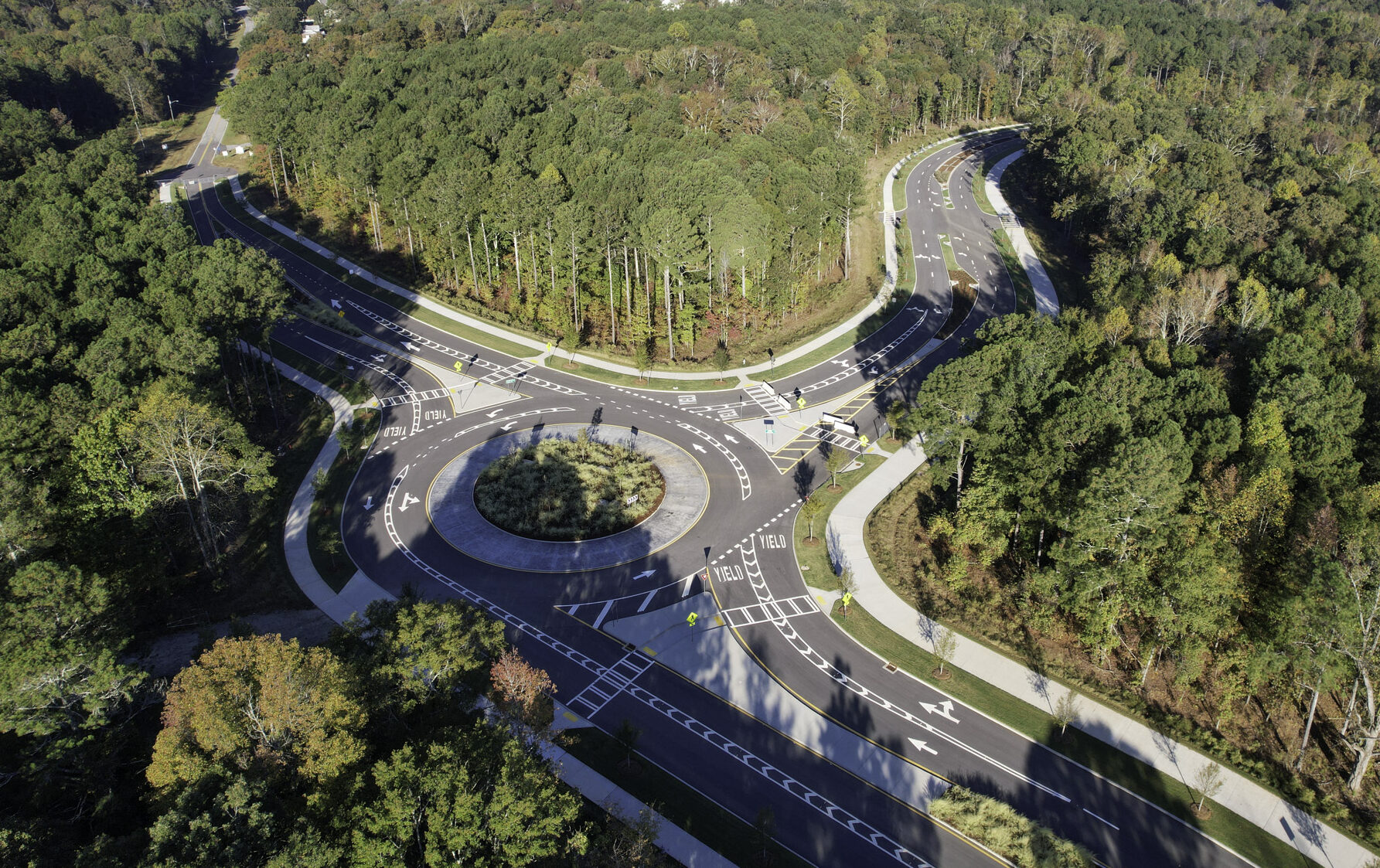new road with roundabout in heavily wooded area