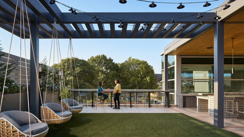patio courtyard with pergola and lights overhead at Roosevelt Hall