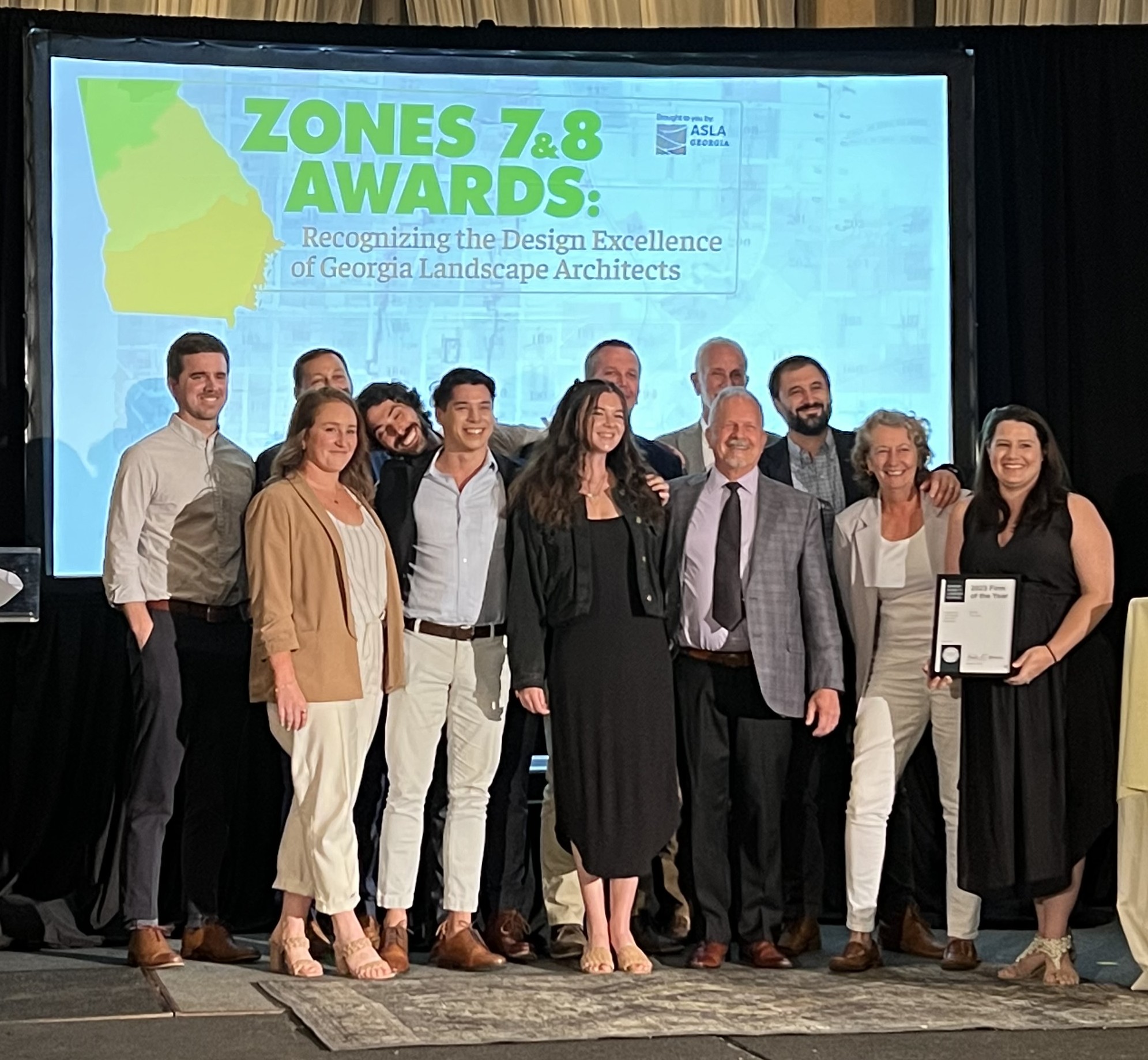 group of people accepting an award on stage