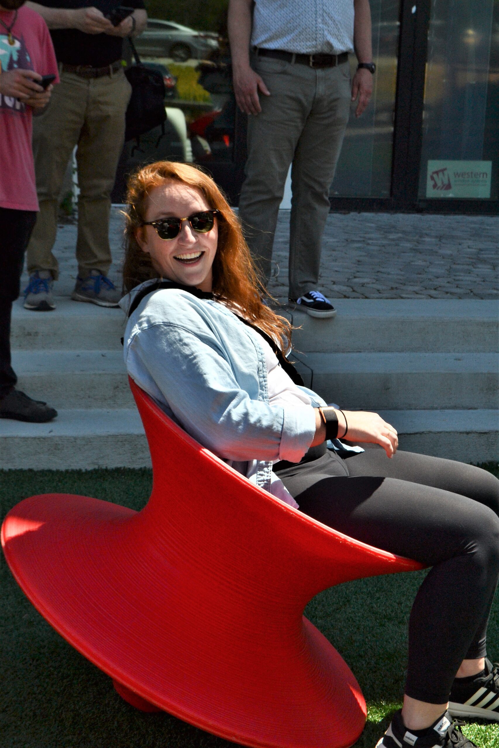 red haired woman sitting on red spinning toy