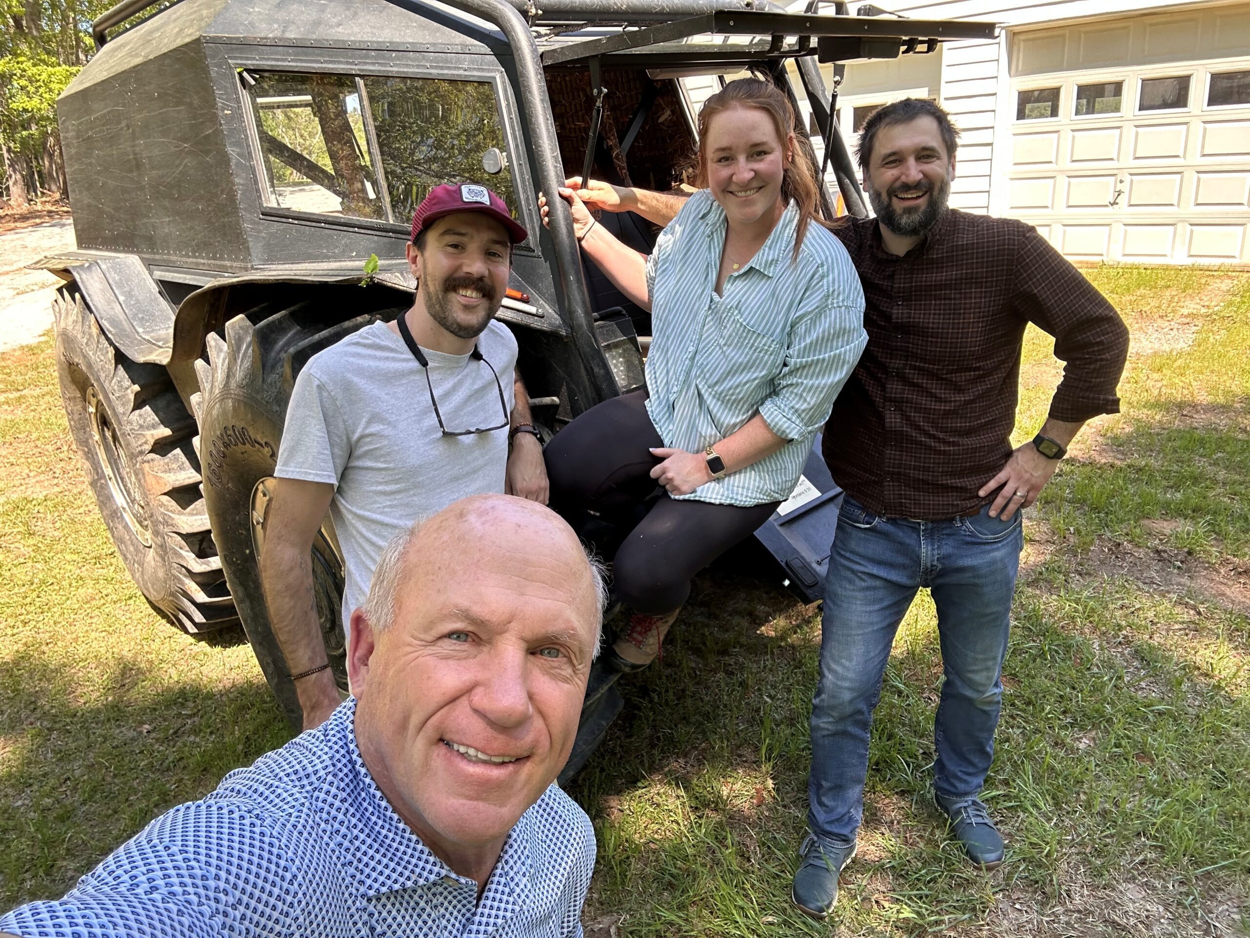 Group in front of off road buggy