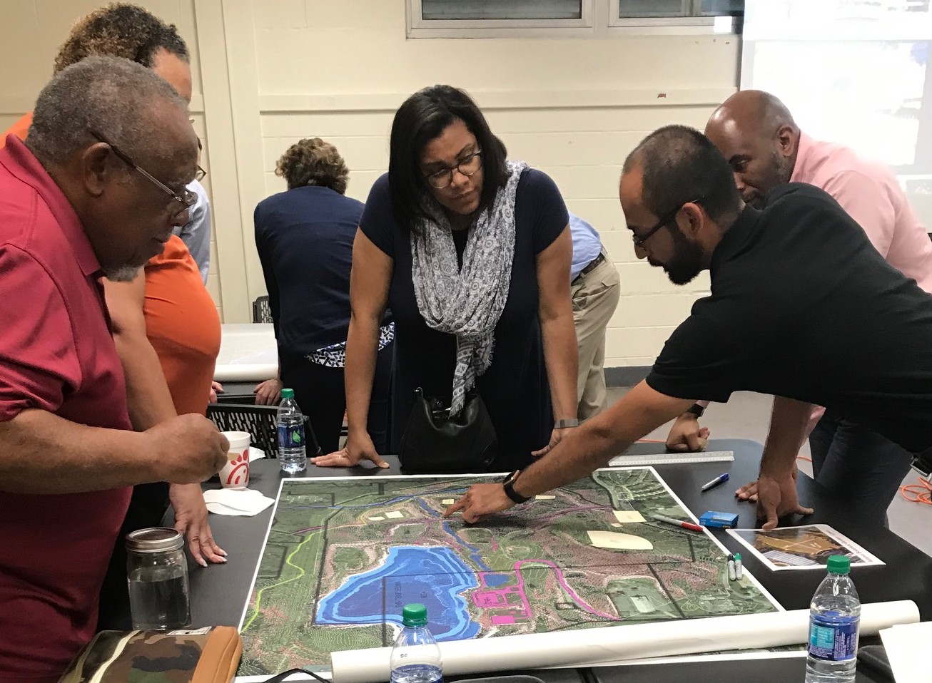 group looking at table with landscape plans